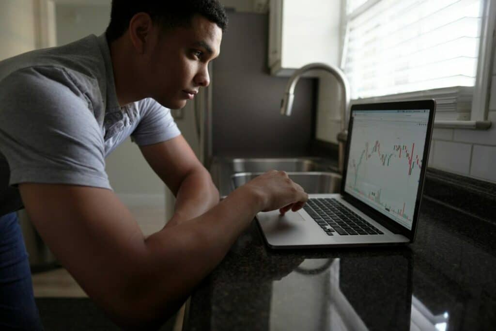 Man checking his investments using a laptop